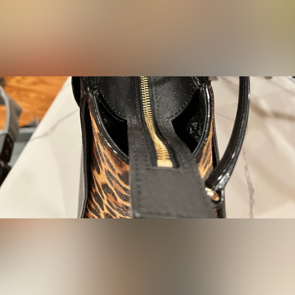 This charming g and fun animal print handbag. It has been sitting in my closet